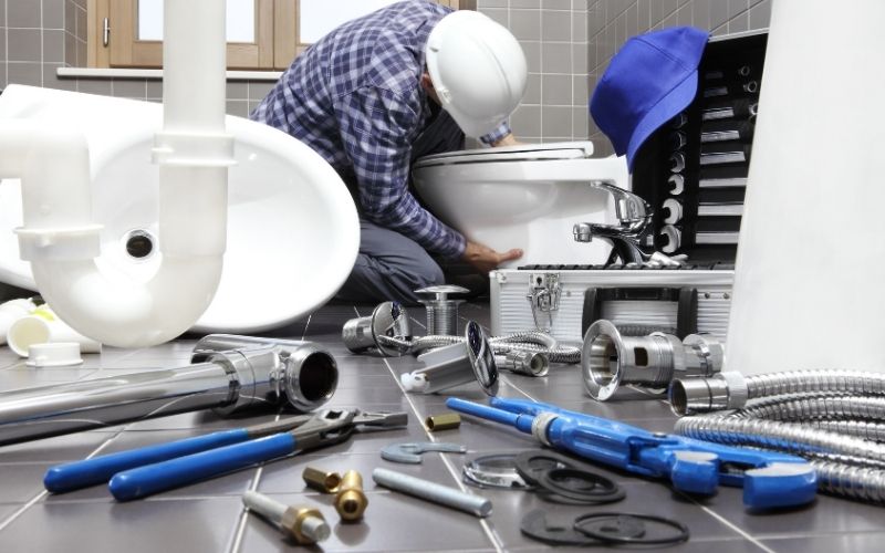 Plumbing repair service. Bowl and bidet with plumbing tools for